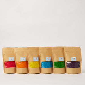 6 separate packs of sensory rice in 6 different shades.